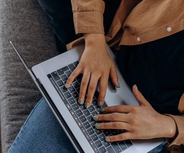 Persona estirándose suavemente junto a un escritorio en una oficina en casa.